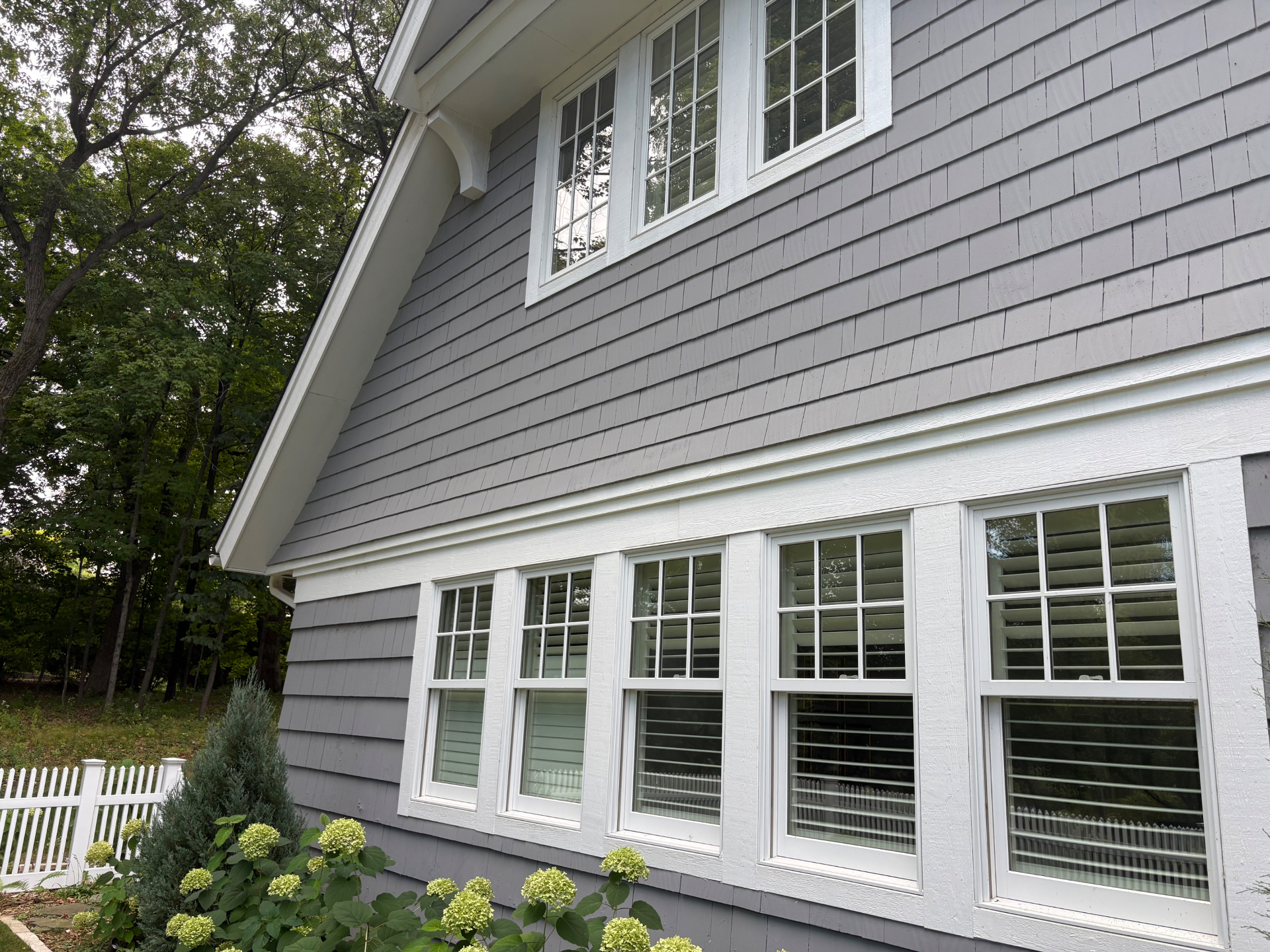 Clean residential windows and exterior trim after service